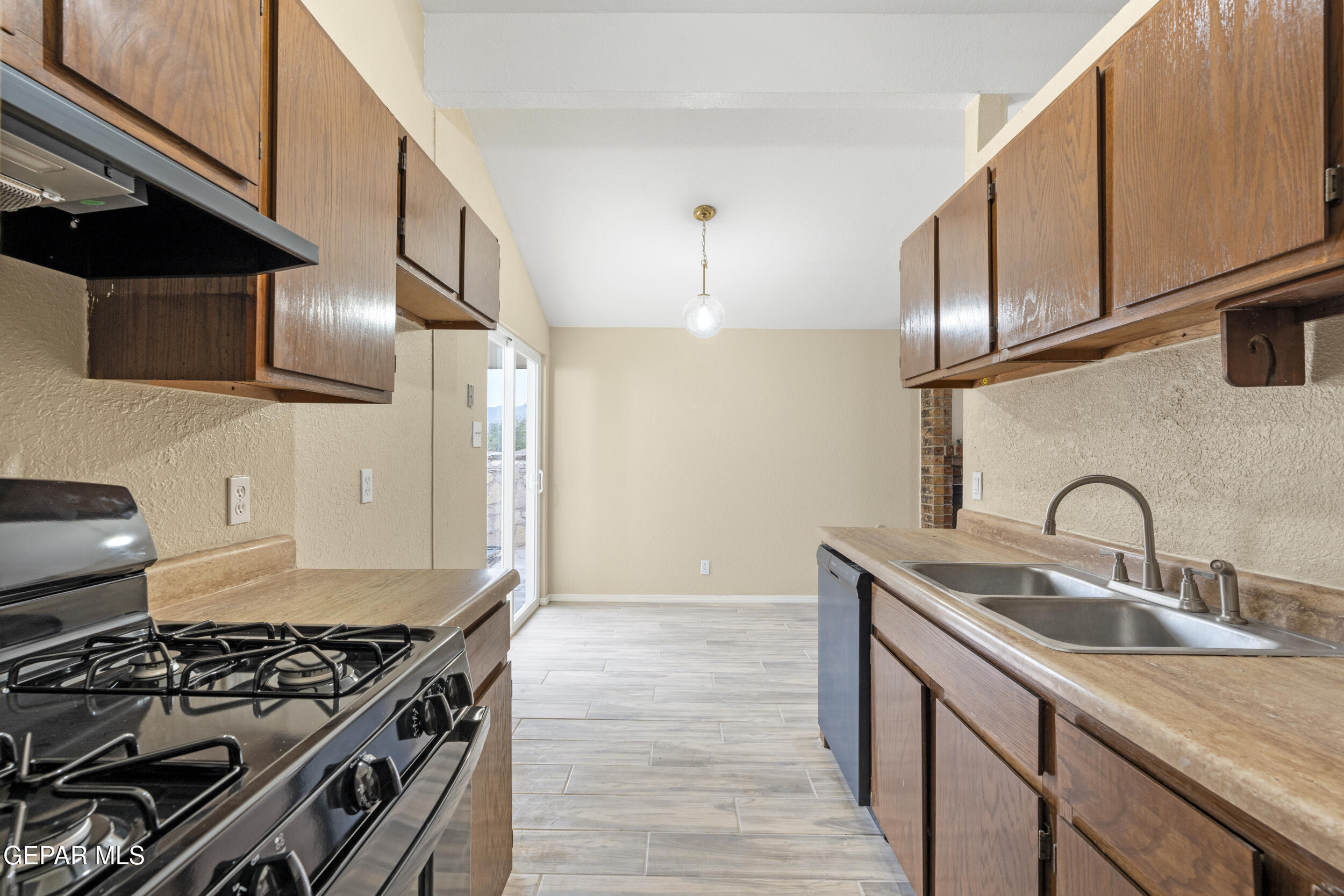 6708 Stone Court El Paso, TX 79924 - Photo 2 of 22 a kitchen with granite countertop a sink and a stove top oven