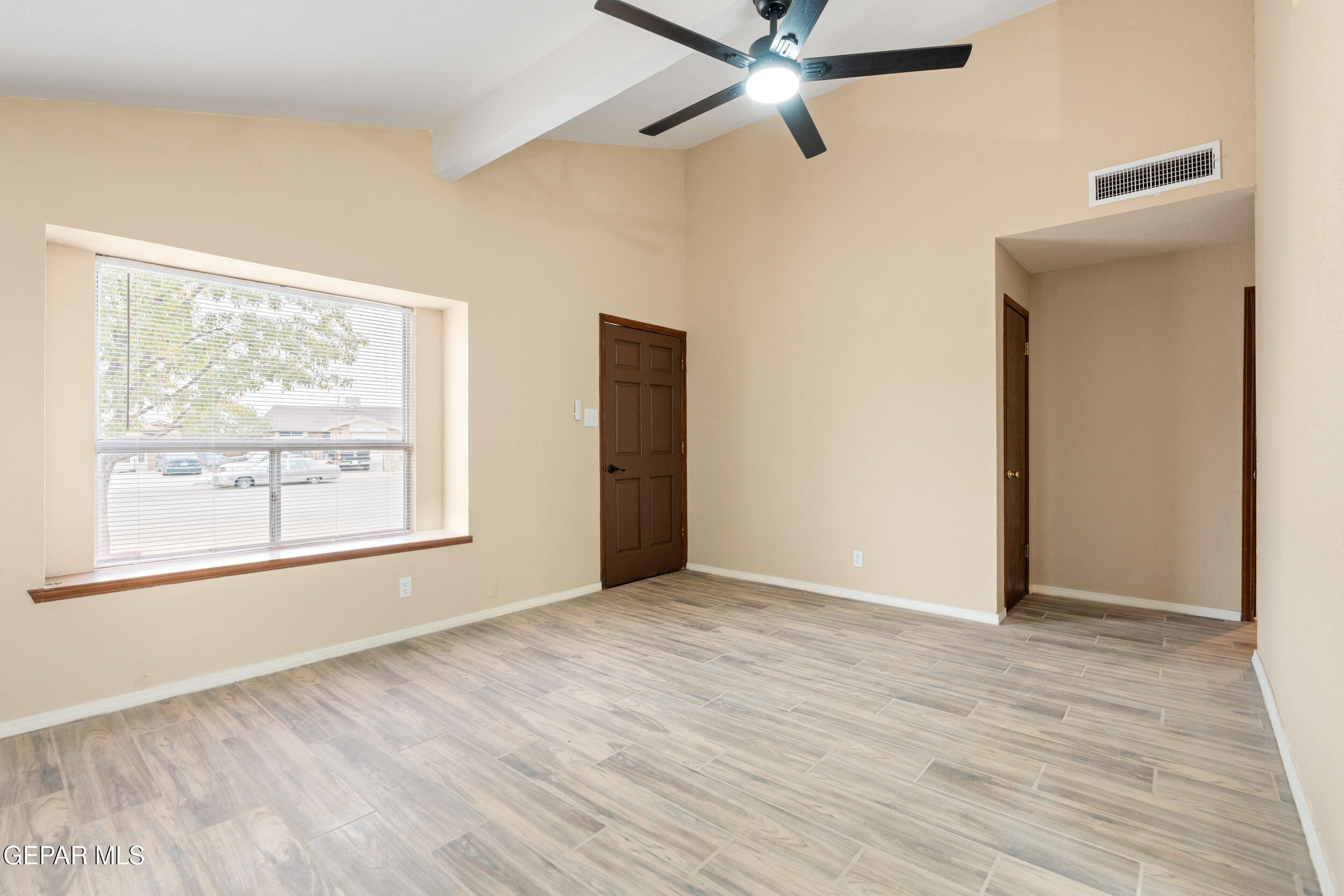 6708 Stone Court El Paso, TX 79924 - Photo 7 of 22 a view of an empty room with wooden floor and a window