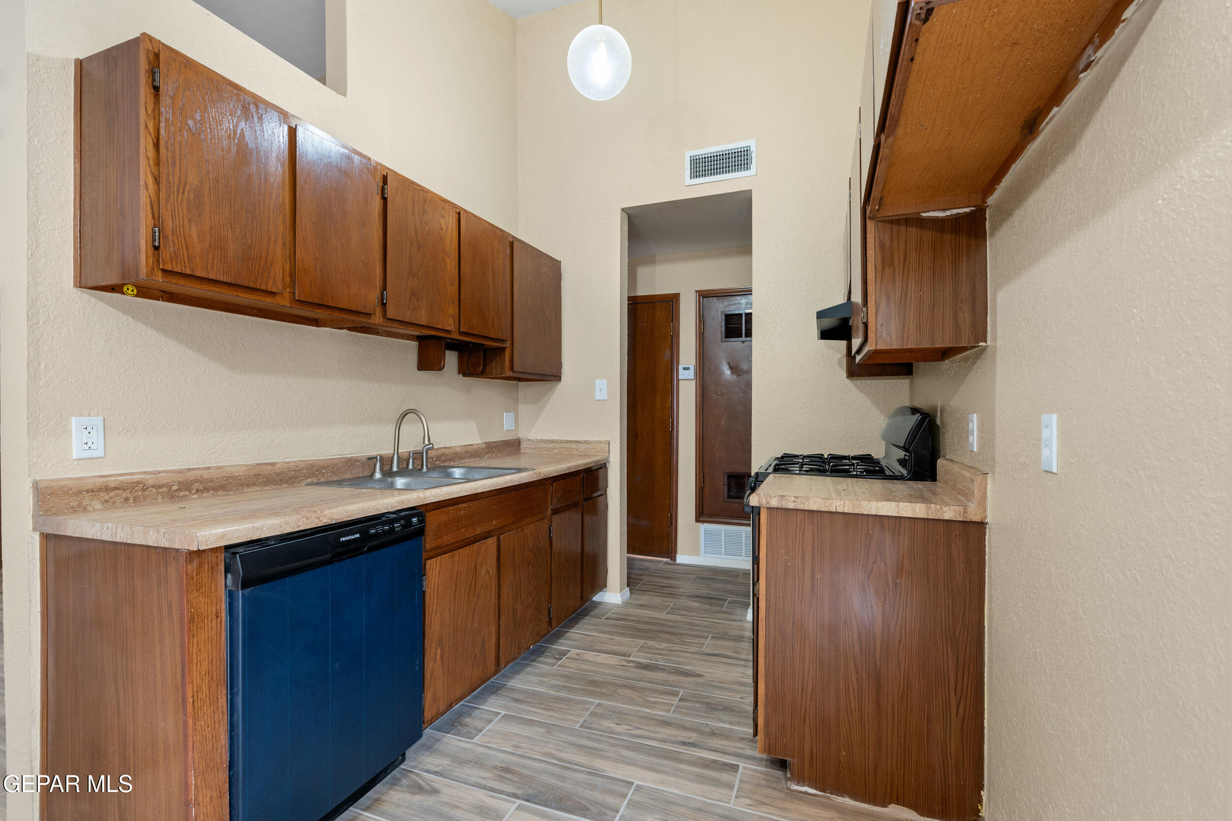 6708 Stone Court El Paso, TX 79924 - Photo 9 of 22 a kitchen with stainless steel appliances granite countertop a sink stove and refrigerator