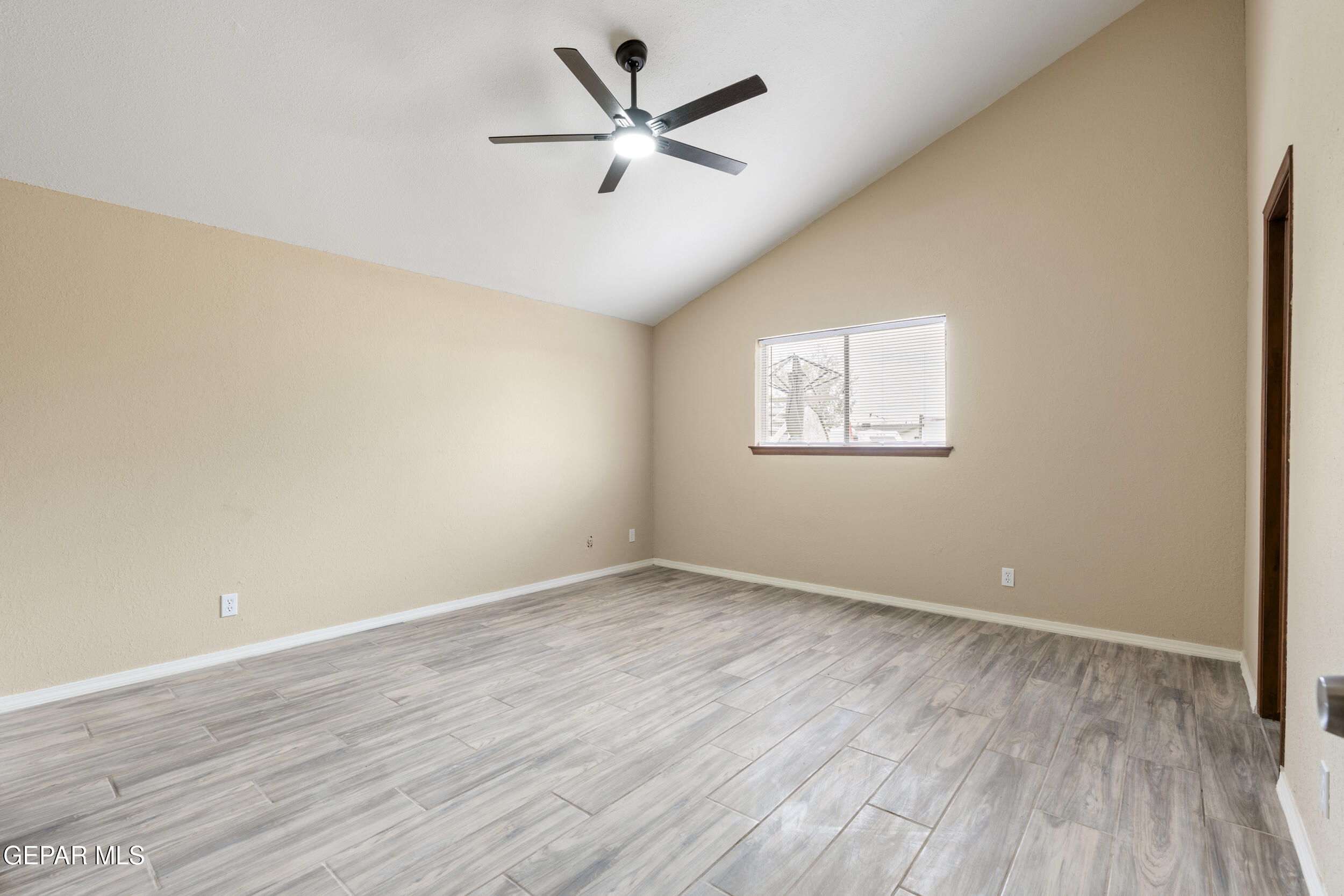 6708 Stone Court El Paso, TX 79924 - Photo 10 of 22 an empty room with wooden floor and windows