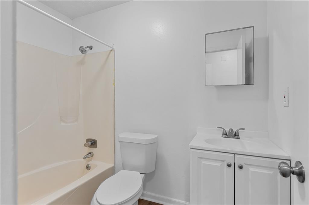 340 Tanglewood Drive, Unit A Monroe, GA 30656 - Photo 11 of 17 a white toilet sitting next to a bath tub