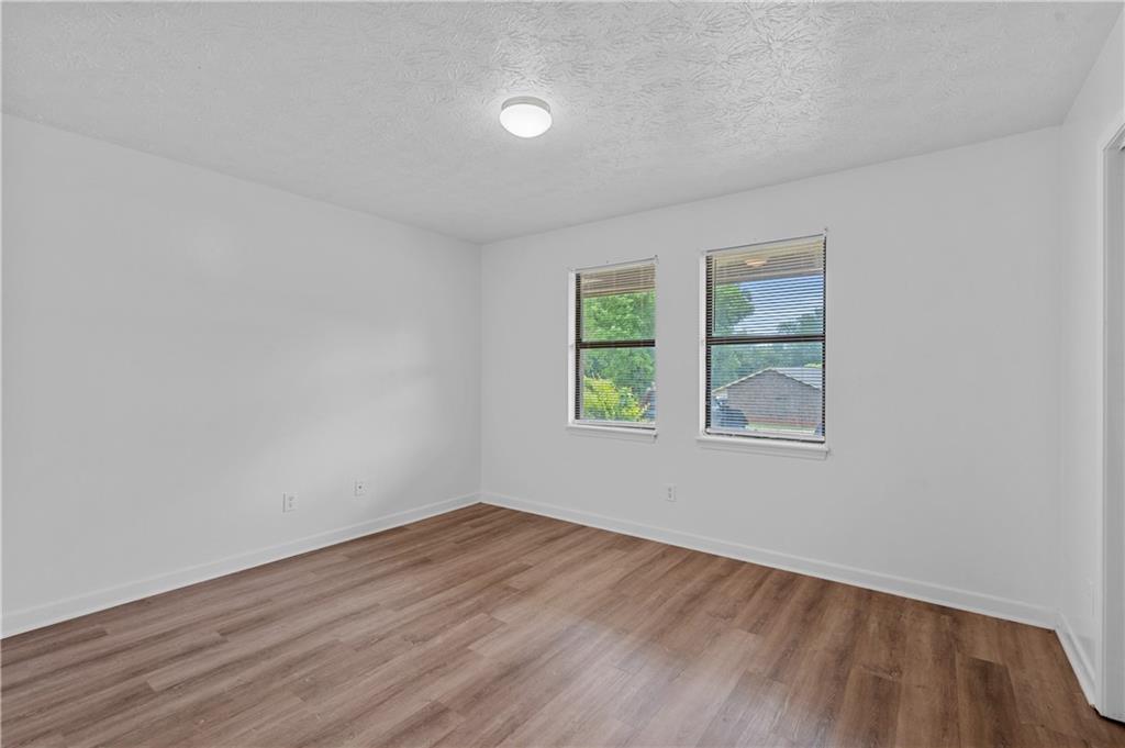 340 Tanglewood Drive, Unit A Monroe, GA 30656 - Photo 14 of 17 an empty room with wooden floor and window