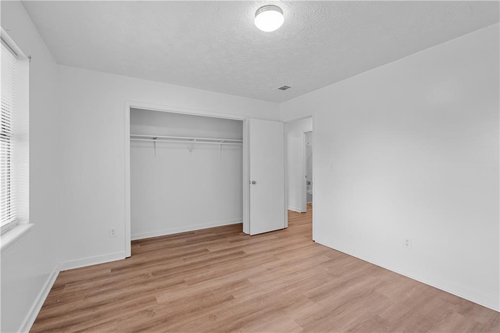 340 Tanglewood Drive, Unit A Monroe, GA 30656 - Photo 15 of 17 a view of an empty room with wooden floor and a window