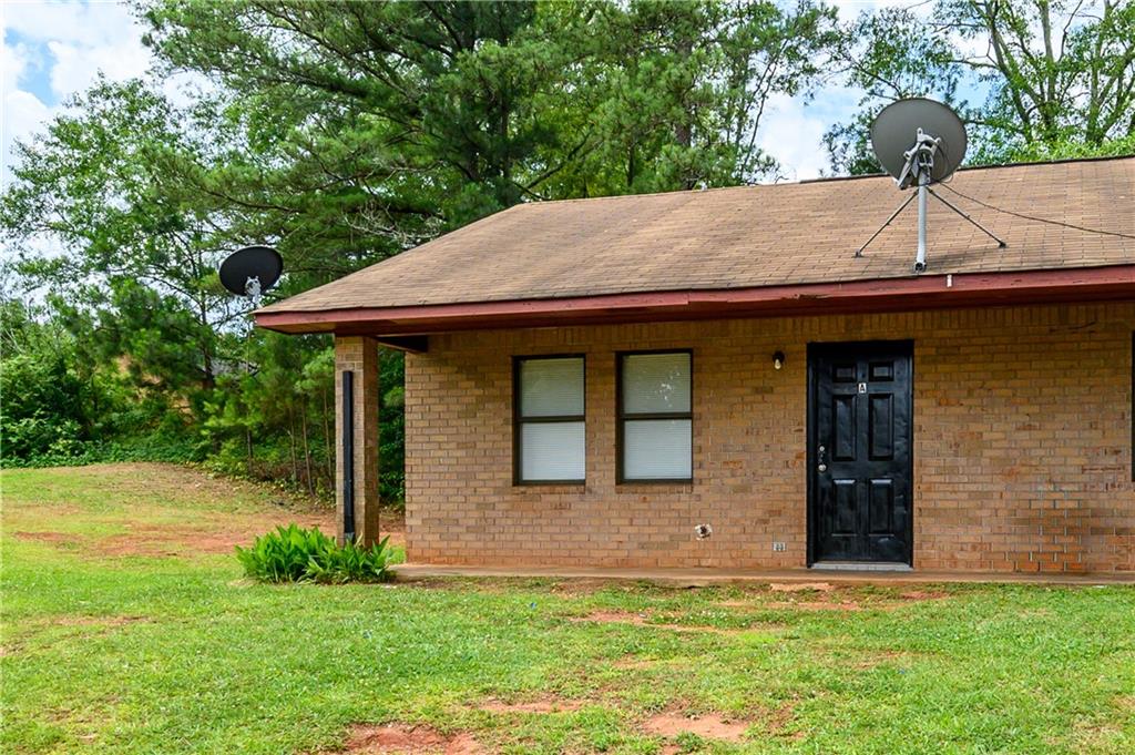 340 Tanglewood Drive, Unit A Monroe, GA 30656 - Photo 16 of 17 a front view of a house with a garden