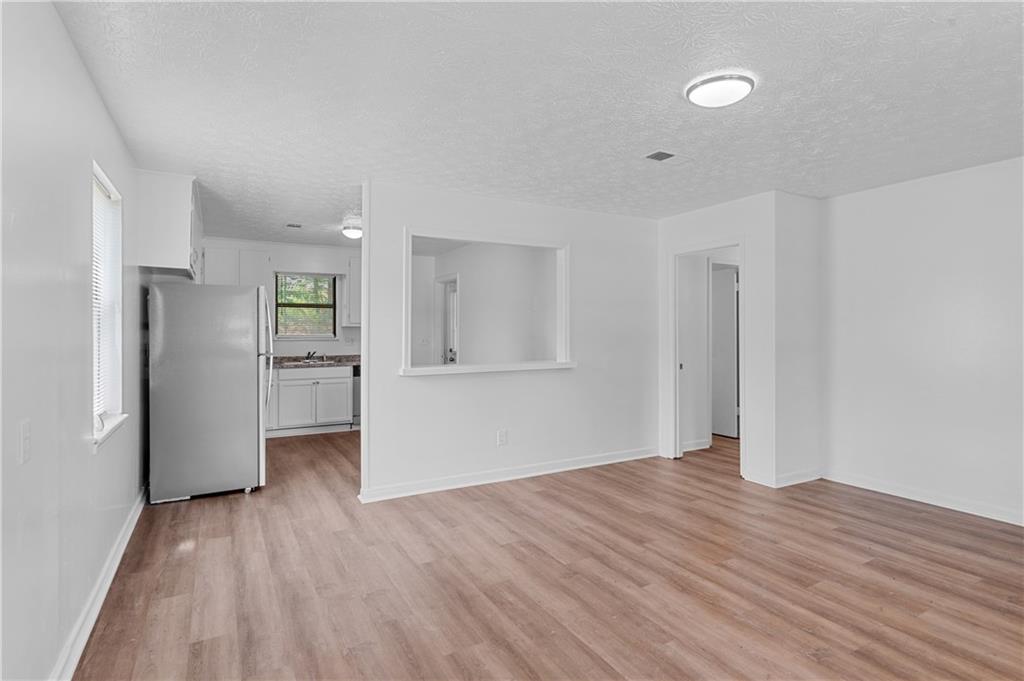 340 Tanglewood Drive, Unit A Monroe, GA 30656 - Photo 4 of 17 a view of empty room with wooden floor