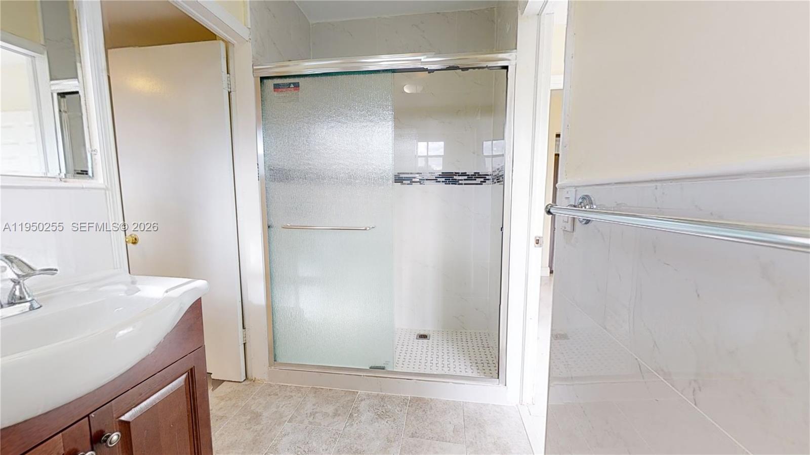 5720 Sheridan Street, Unit 1 Hollywood, FL 33021 - Photo 11 of 14 a bathroom with a sink and shower