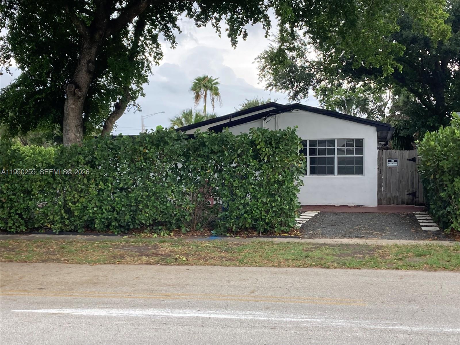 5720 Sheridan Street, Unit 1 Hollywood, FL 33021 - Photo 12 of 14 a front view of a house with a yard and garage