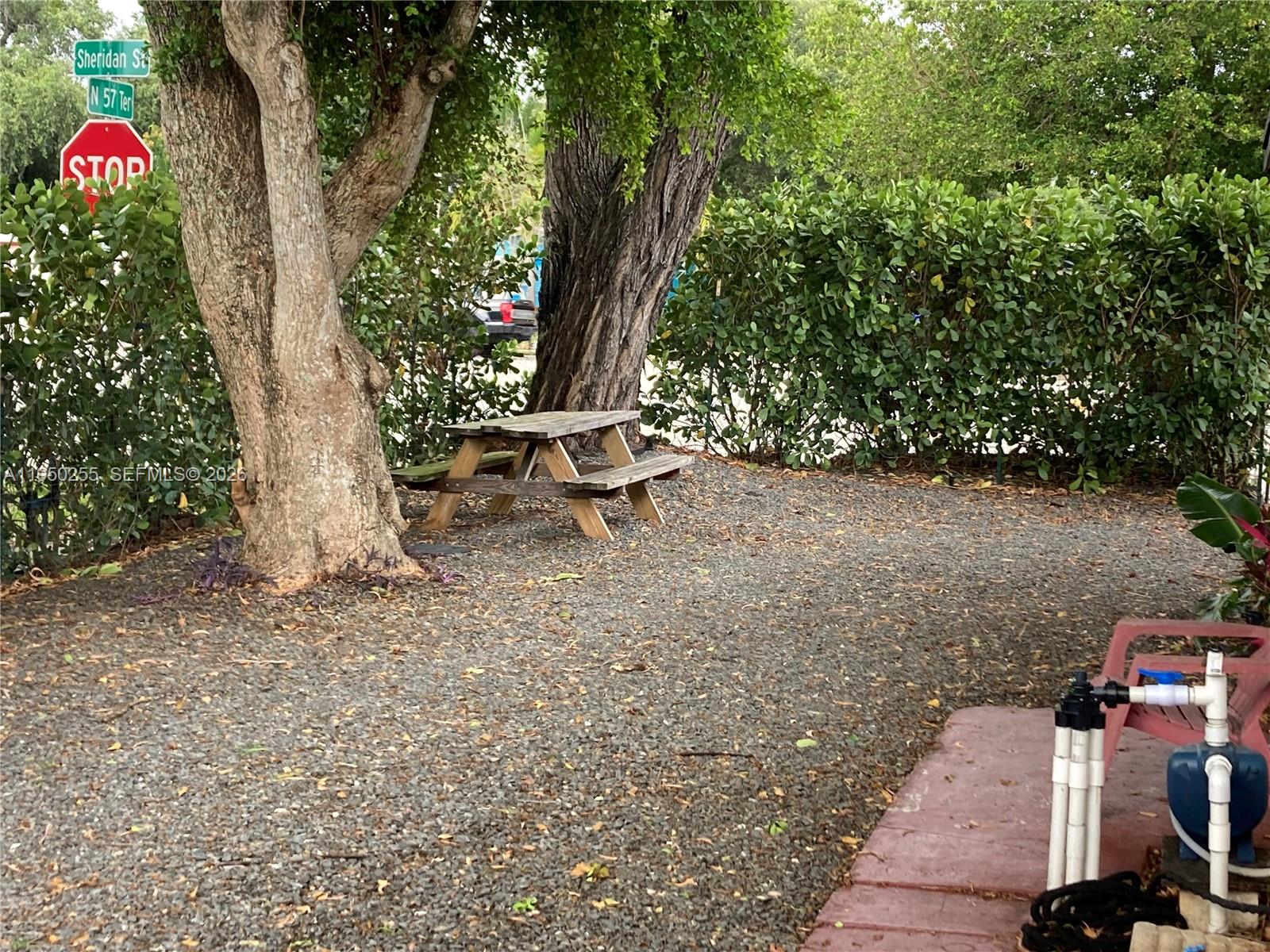 5720 Sheridan Street, Unit 1 Hollywood, FL 33021 - Photo 13 of 14 a view of a bench in a backyard
