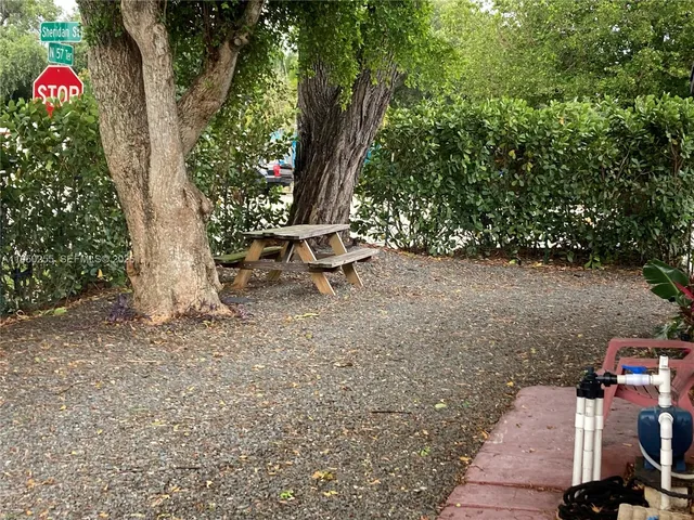 a view of house with backyard and chair