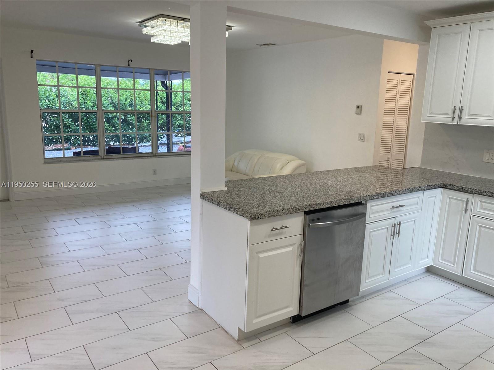 5720 Sheridan Street, Unit 1 Hollywood, FL 33021 - Photo 4 of 14 a kitchen with granite countertop white cabinets and a granite counter tops