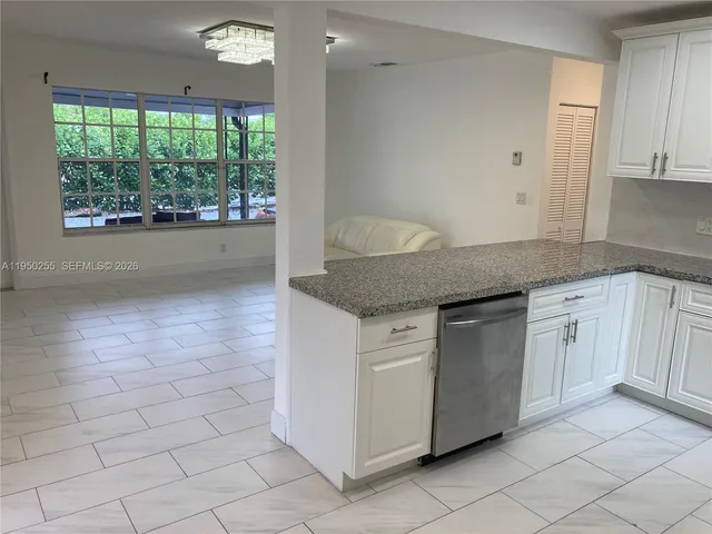 a kitchen with granite countertop white cabinets and a granite counter tops