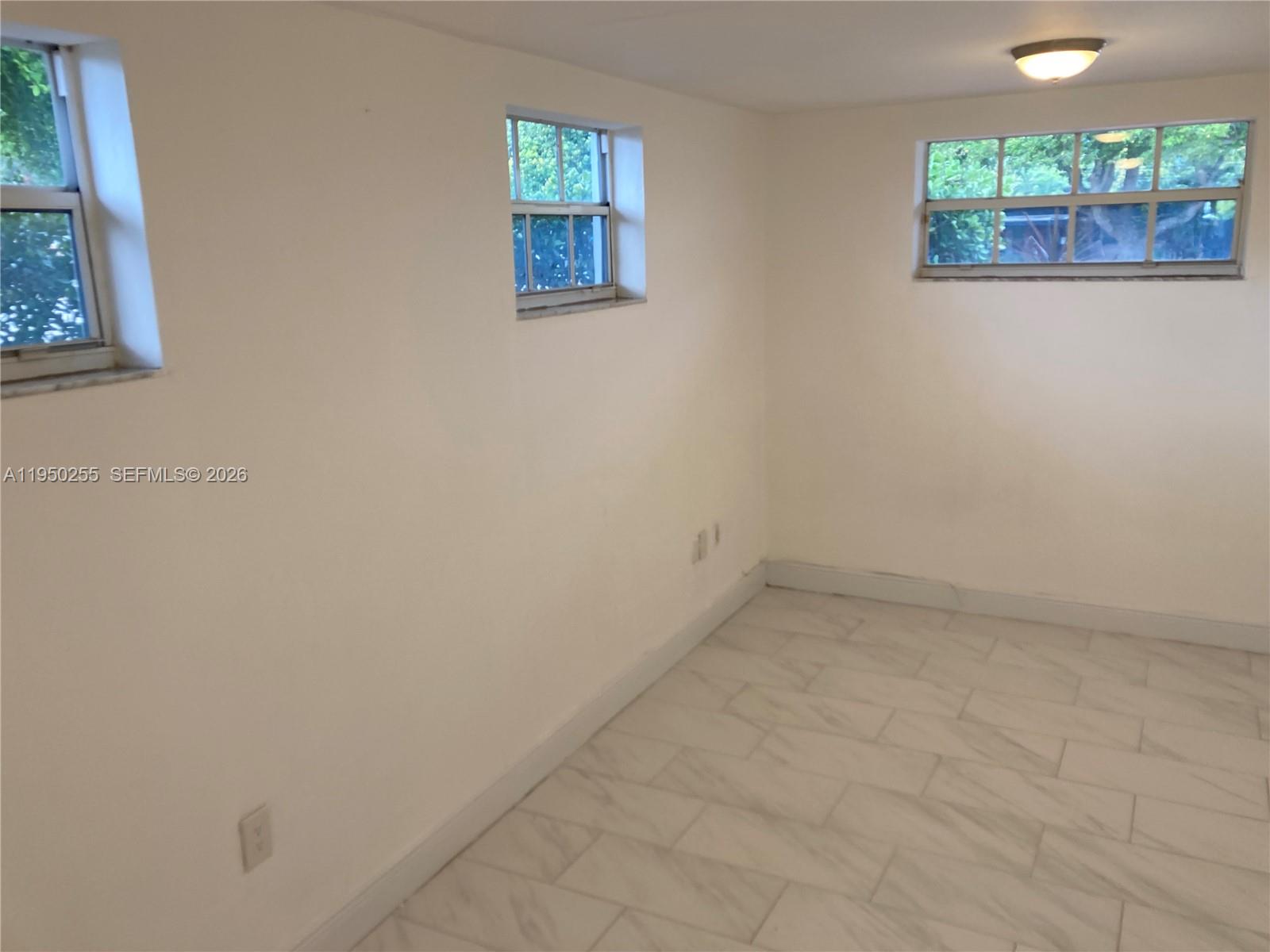 5720 Sheridan Street, Unit 1 Hollywood, FL 33021 - Photo 5 of 14 an empty room with a window