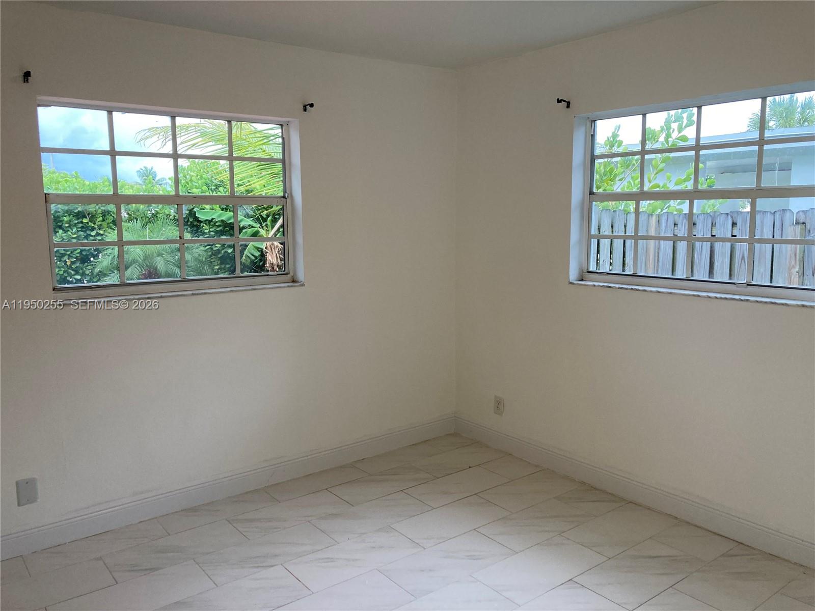5720 Sheridan Street, Unit 1 Hollywood, FL 33021 - Photo 6 of 14 an empty room with a window