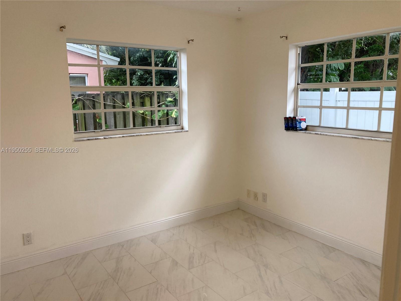 5720 Sheridan Street, Unit 1 Hollywood, FL 33021 - Photo 7 of 14 an empty room with a window