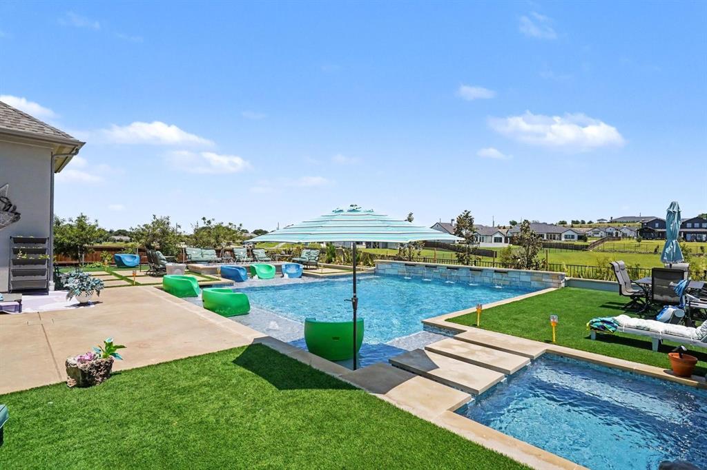 573 Broadleaf Way Haslet, TX 76052 - Photo 29 of 35 a view of a swimming pool and lounge chairs in the garden