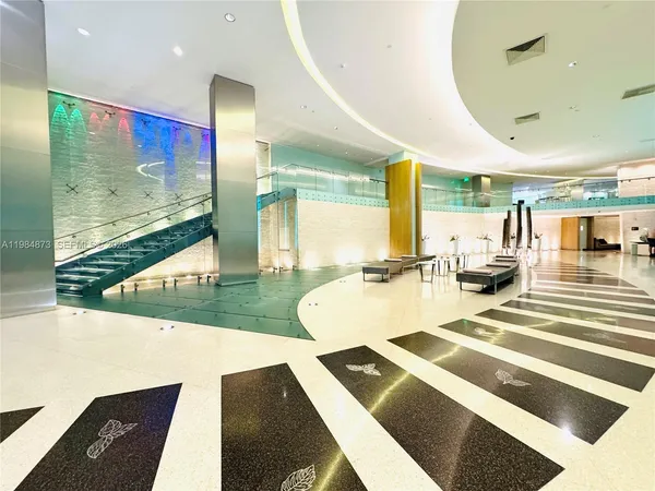 a view of a dining room with furniture and a floor to ceiling window