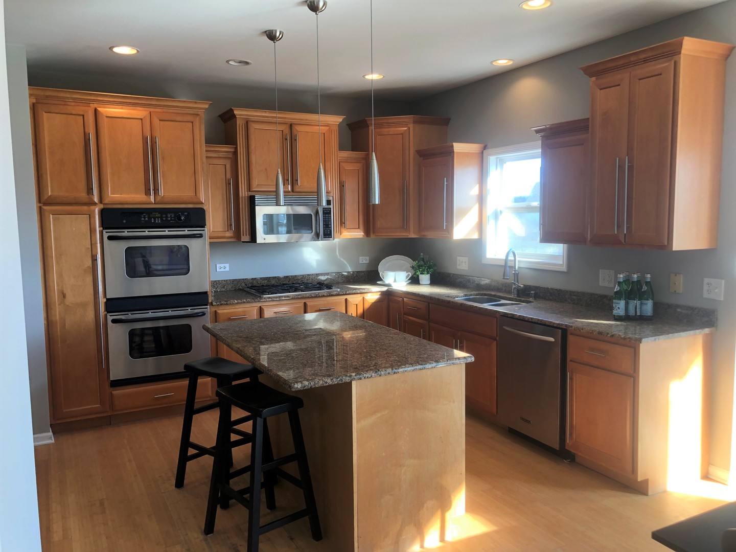 13315 Blakely Drive Plainfield, IL 60585 - Photo 4 of 20 a kitchen with a sink a stove a microwave a counter top space and cabinets