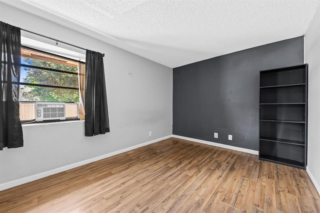 4902 Northwest 82nd Avenue, Unit 2001 Fort Lauderdale, FL 33351 - Photo 15 of 23 a view of an empty room with a window and wooden floor