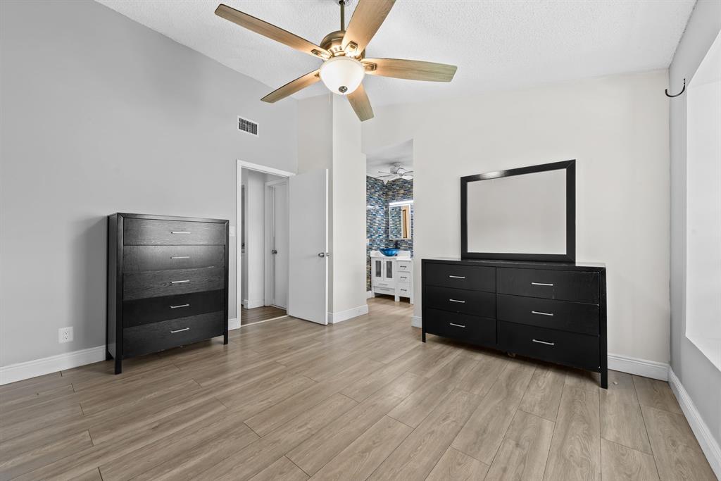 4902 Northwest 82nd Avenue, Unit 2001 Fort Lauderdale, FL 33351 - Photo 17 of 23 a living room with a dresser with wooden floor