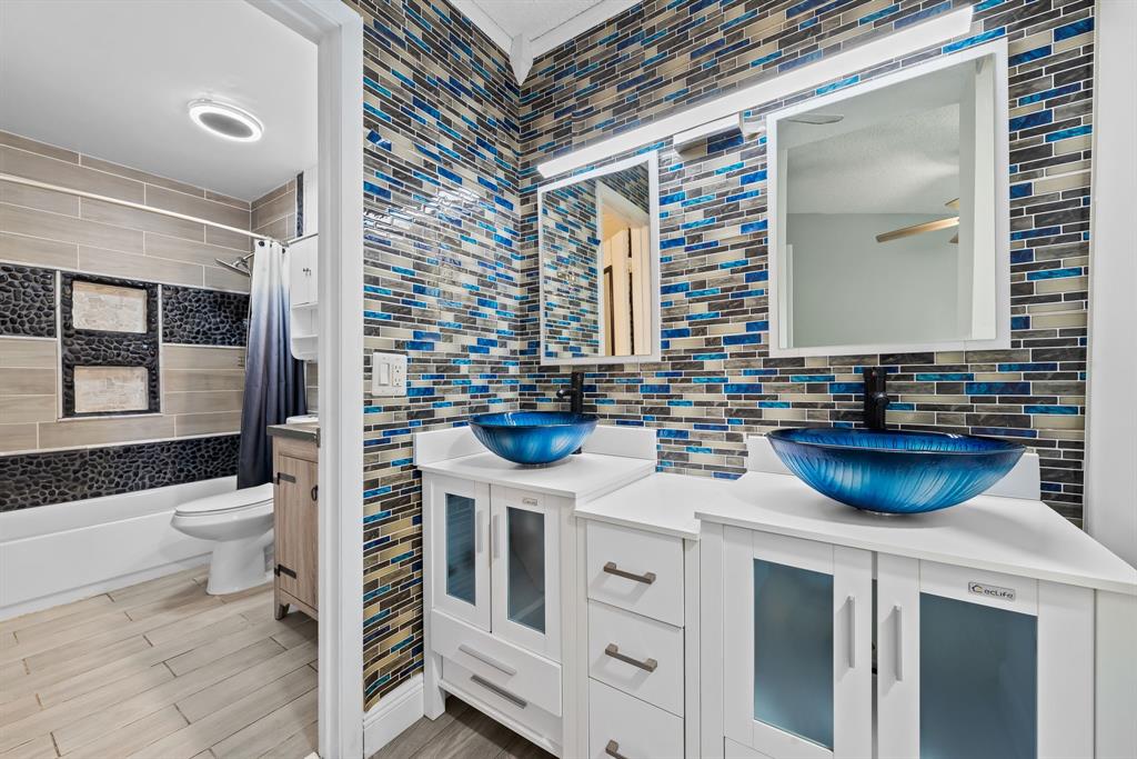 4902 Northwest 82nd Avenue, Unit 2001 Fort Lauderdale, FL 33351 - Photo 18 of 23 a bathroom with a sink a toilet and a mirror