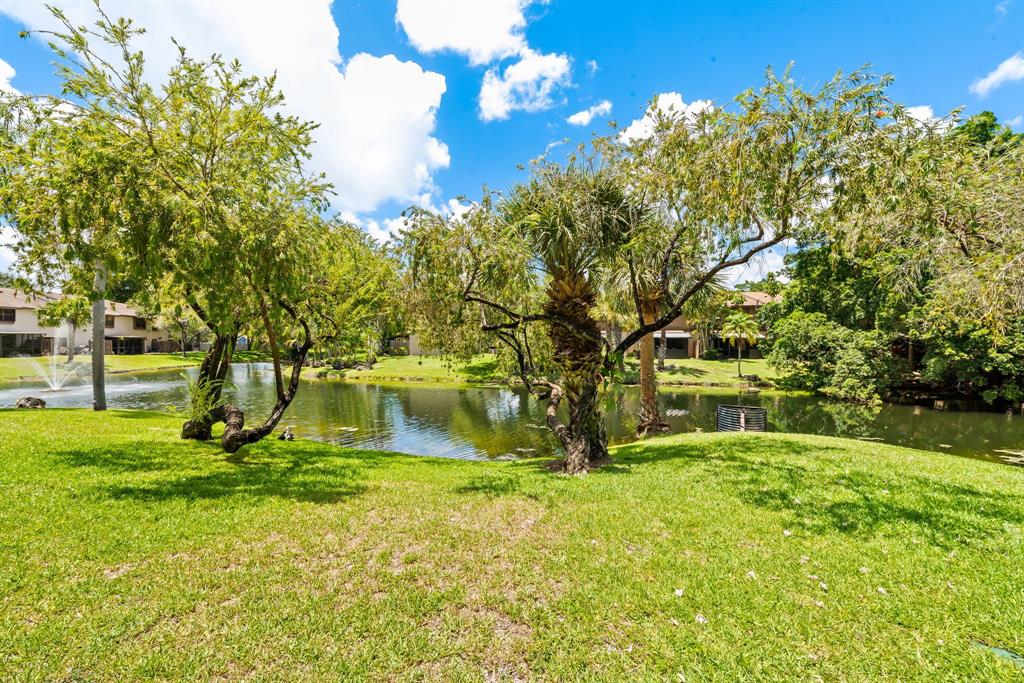 4902 Northwest 82nd Avenue, Unit 2001 Fort Lauderdale, FL 33351 - Photo 2 of 23 a view of a backyard with large trees