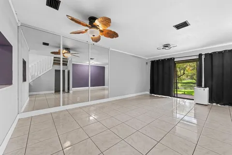 a view of a livingroom with a ceiling fan and window
