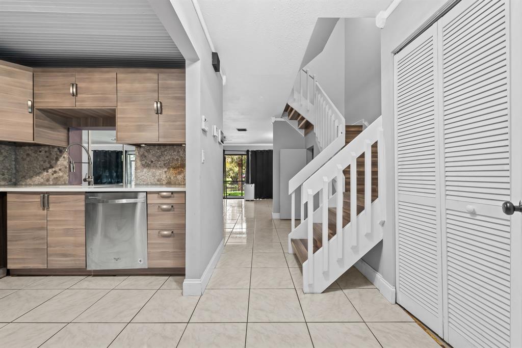 4902 Northwest 82nd Avenue, Unit 2001 Fort Lauderdale, FL 33351 - Photo 5 of 23 a view of a hallway with entryway and kitchen