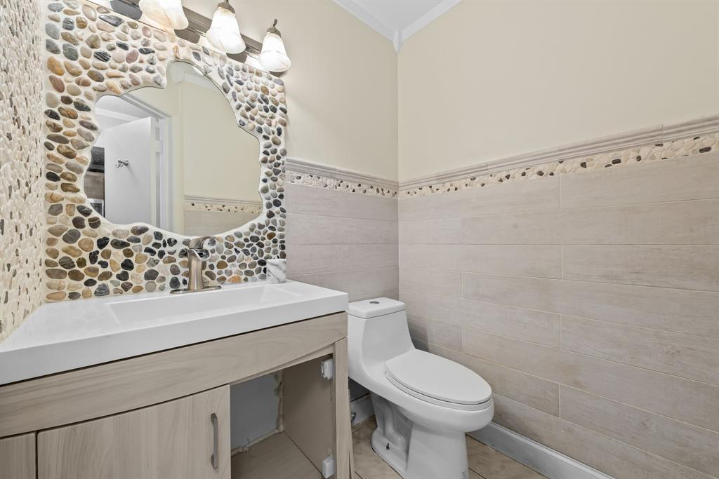 4902 Northwest 82nd Avenue, Unit 2001 Fort Lauderdale, FL 33351 - Photo 8 of 23 a bathroom with a sink a toilet and shower