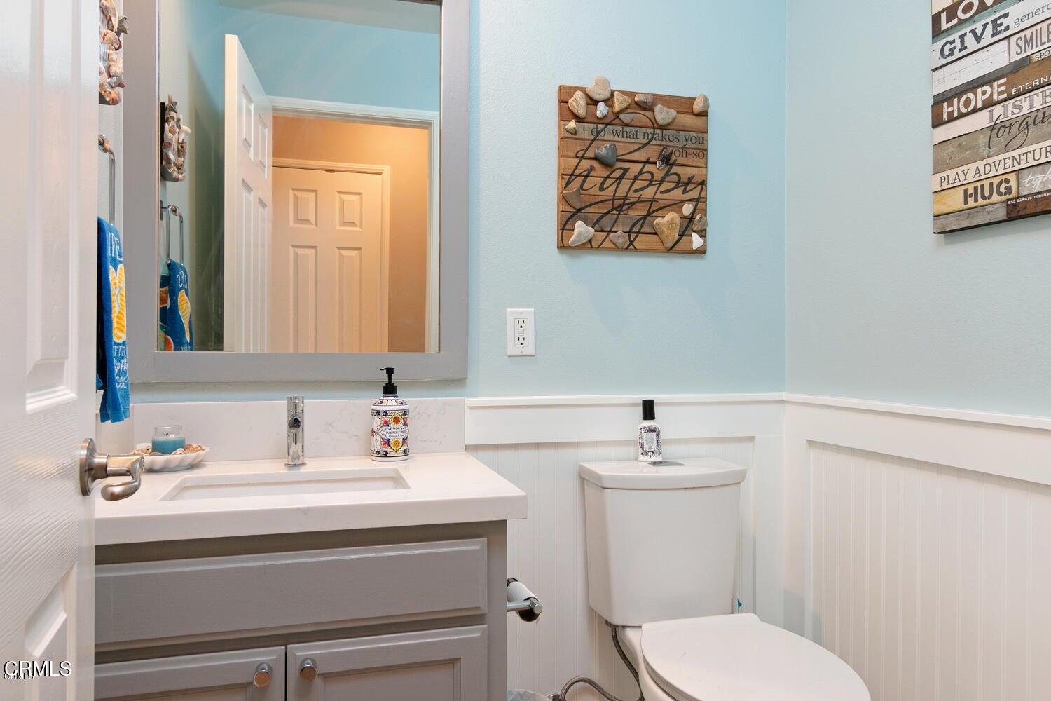925 Dunes Street Oxnard, CA 93035 - Photo 19 of 27 a bathroom with a sink mirror and toilet