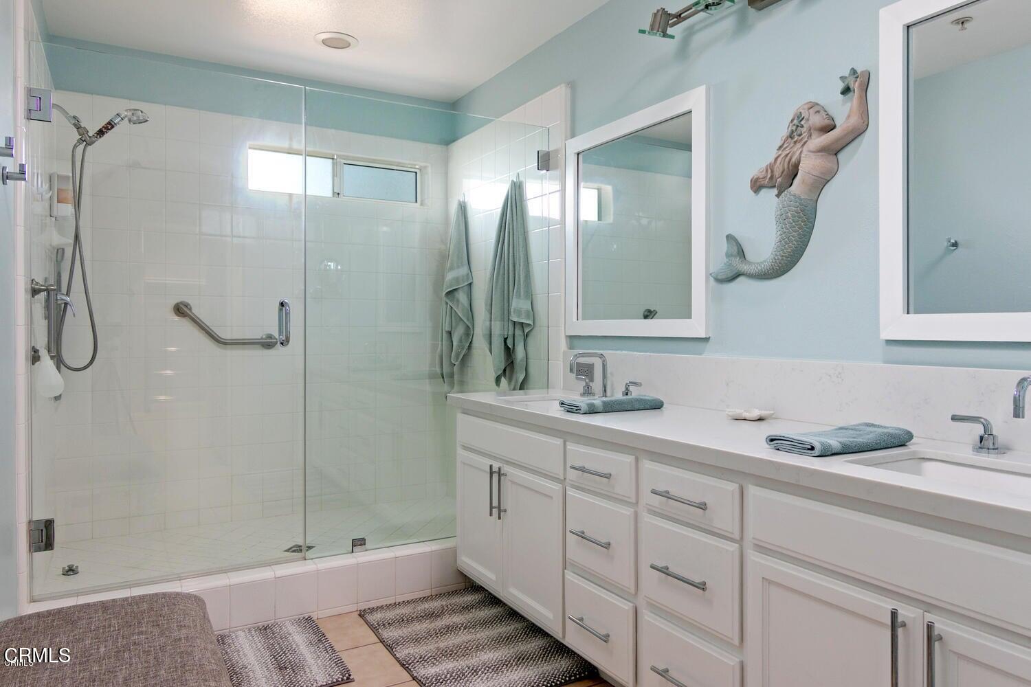 925 Dunes Street Oxnard, CA 93035 - Photo 23 of 27 a bathroom with a double vanity sink mirror and shower