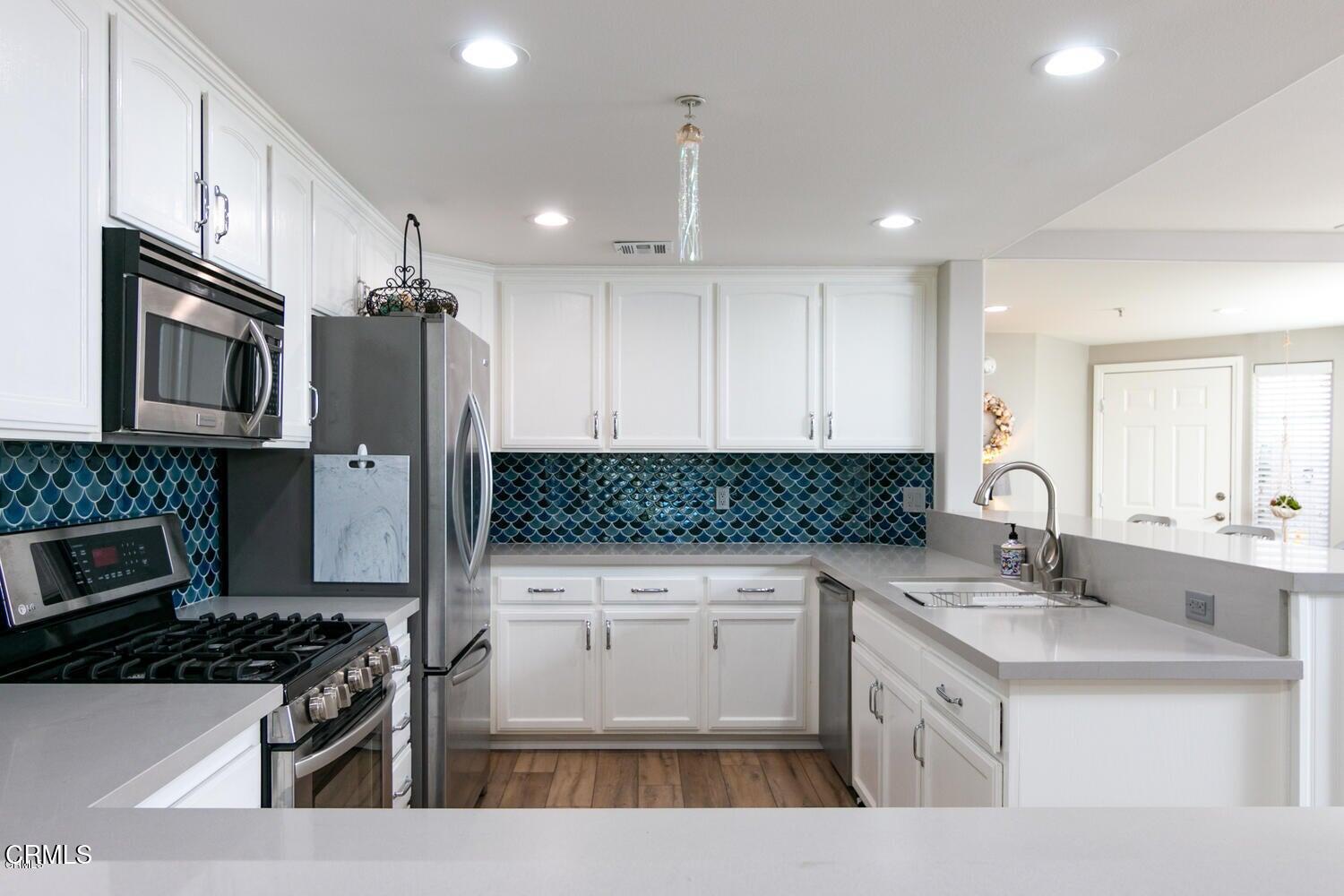 925 Dunes Street Oxnard, CA 93035 - Photo 6 of 27 a kitchen with stainless steel appliances granite countertop a sink stove and refrigerator