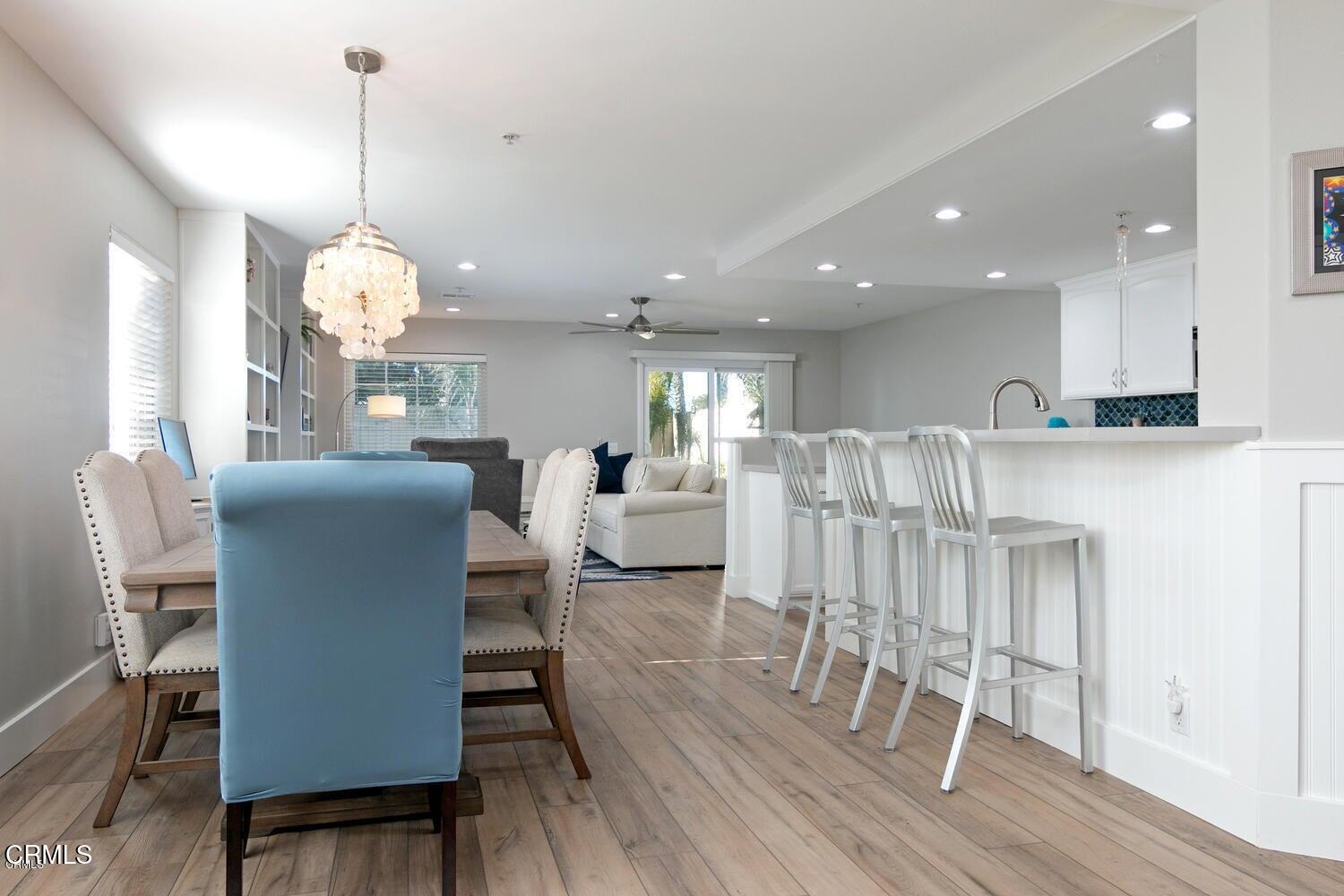 925 Dunes Street Oxnard, CA 93035 - Photo 9 of 27 a living room with furniture a dining table and a chandelier