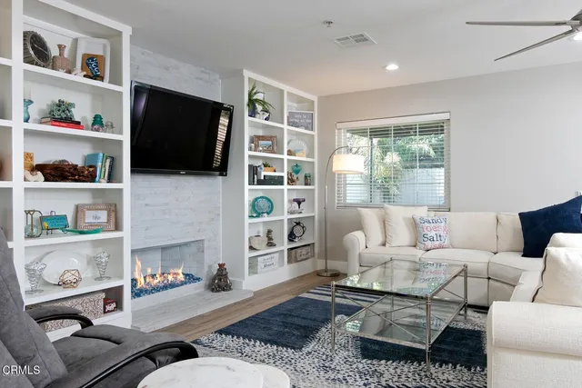 a living room with furniture and a fireplace