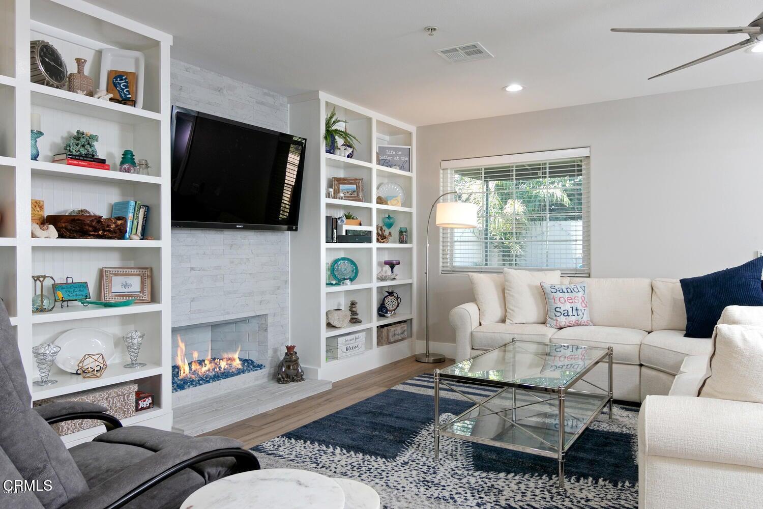 925 Dunes Street Oxnard, CA 93035 - Photo 10 of 27 a living room with furniture a flat screen tv and a fireplace