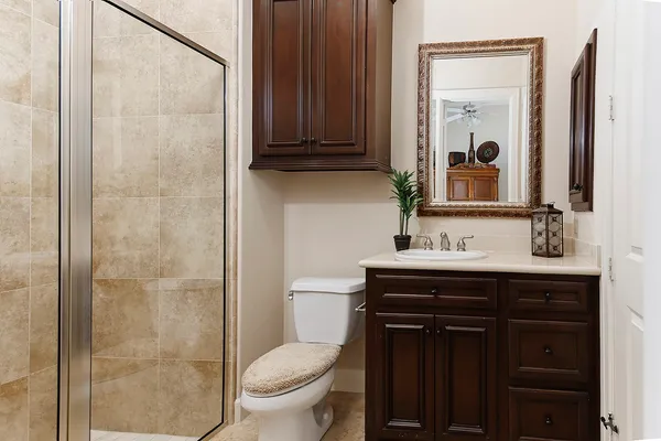 a bathroom with a sink a toilet and shower