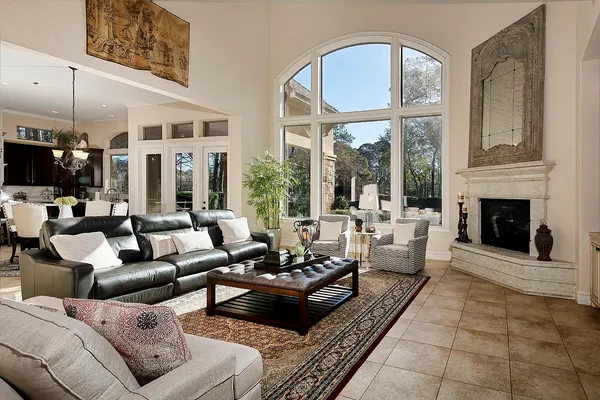 a living room with furniture large window and a fireplace