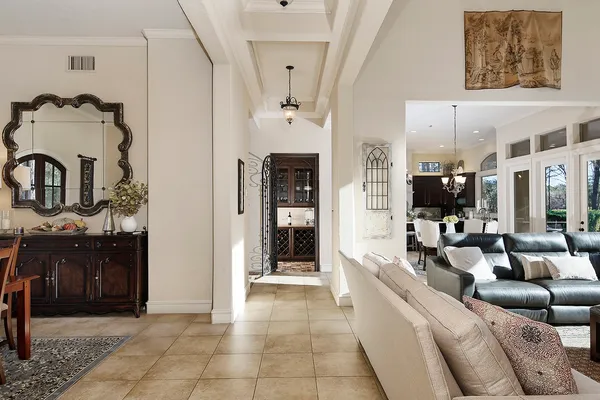 a living room with furniture a chandelier and a fireplace