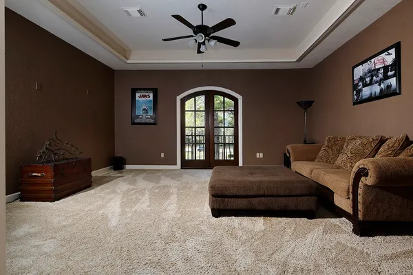 a spacious bedroom with a bed and a dresser