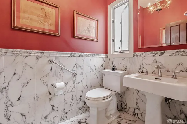 a bathroom with a granite countertop toilet and a shower