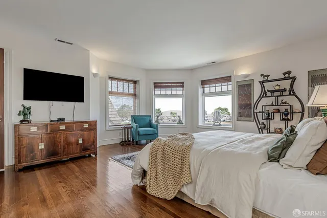 a bedroom with a bed and a dresser in it