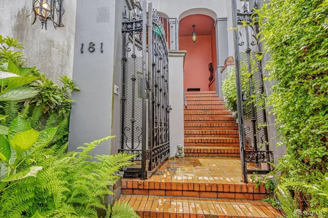 a view of a hallway with wooden floor and a rug