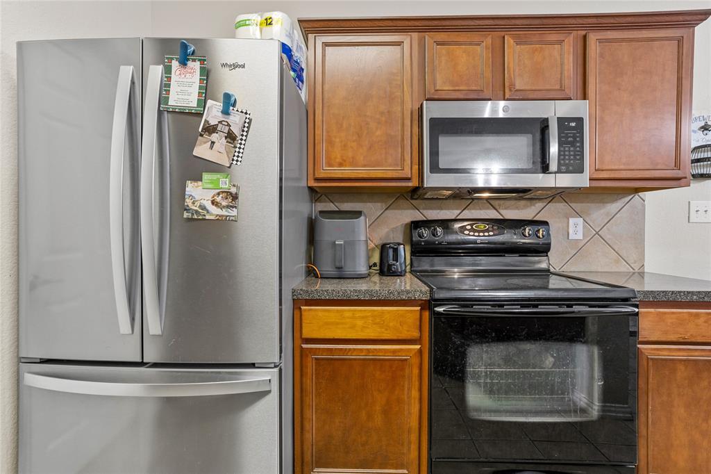 3404 Belladonna Drive Plano, TX 75093 - Photo 11 of 24 a kitchen with a stove and a microwave