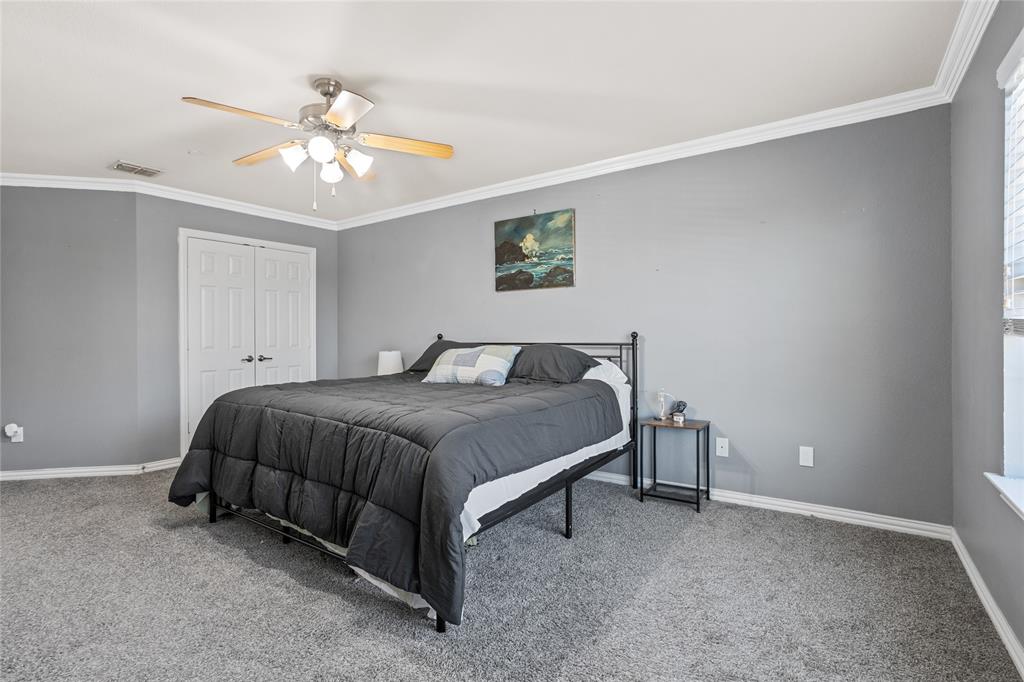3404 Belladonna Drive Plano, TX 75093 - Photo 14 of 24 a spacious bedroom with a bed and a chandelier