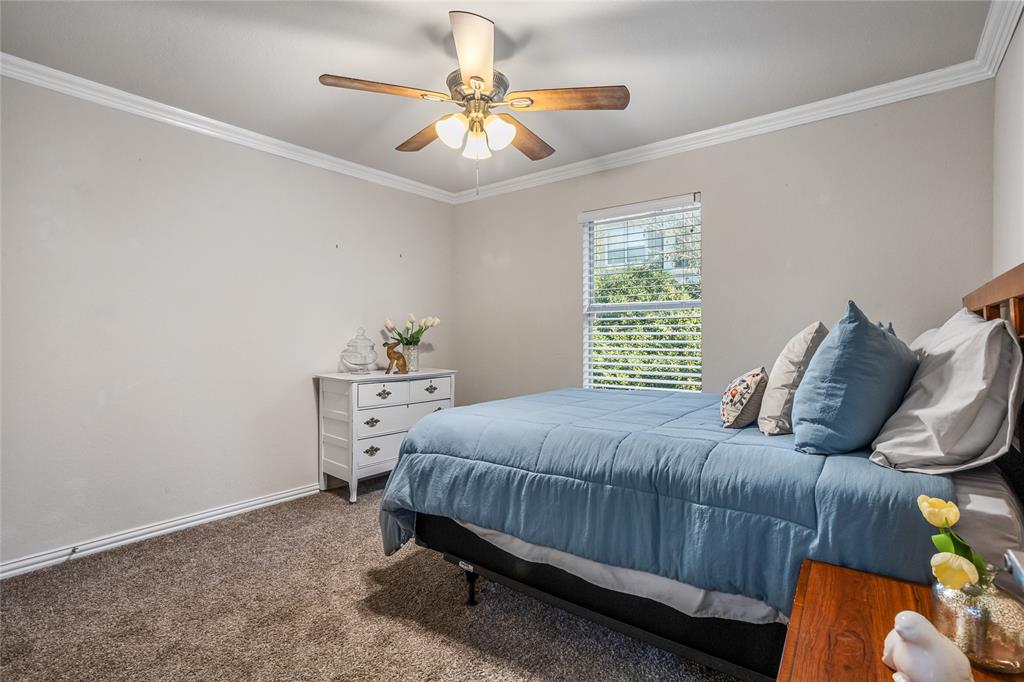 3404 Belladonna Drive Plano, TX 75093 - Photo 18 of 24 a bedroom with a bed and a chandelier