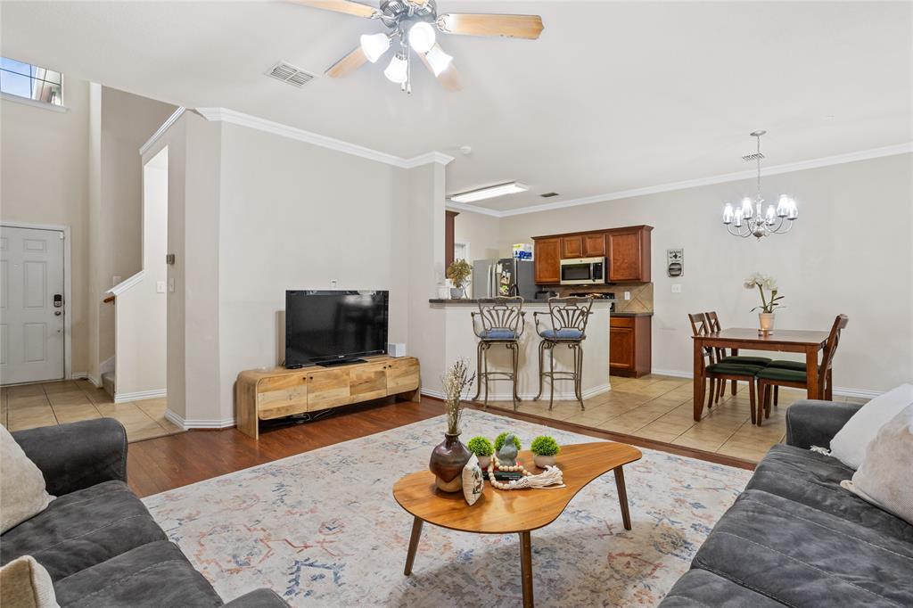 3404 Belladonna Drive Plano, TX 75093 - Photo 7 of 24 a living room with furniture and a dining table with wooden floor