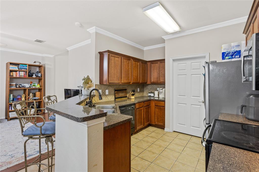 3404 Belladonna Drive Plano, TX 75093 - Photo 9 of 24 a kitchen with stainless steel appliances granite countertop a refrigerator stove and sink