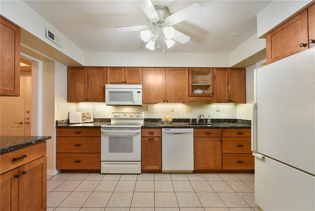 300 Fox Chapel Road, Unit 405 Pittsburgh, PA 15238 - Photo 12 of 30 a kitchen with stainless steel appliances granite countertop a stove sink and cabinets