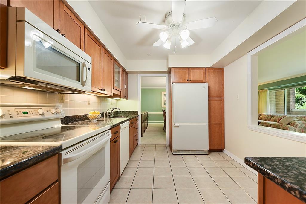 300 Fox Chapel Road, Unit 405 Pittsburgh, PA 15238 - Photo 13 of 30 a kitchen with a stove a refrigerator and cabinets