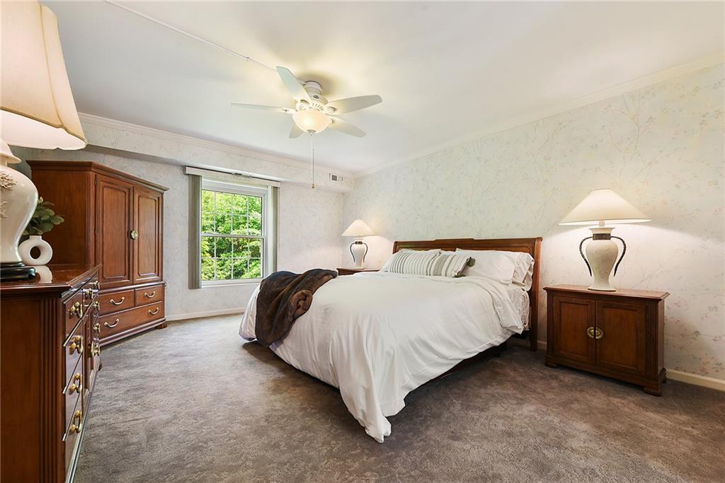 300 Fox Chapel Road, Unit 405 Pittsburgh, PA 15238 - Photo 21 of 30 a bed room with a bed and a chandelier