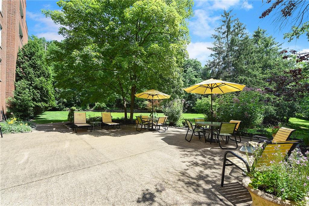 300 Fox Chapel Road, Unit 405 Pittsburgh, PA 15238 - Photo 30 of 30 an outdoor space with furniture and umbrella
